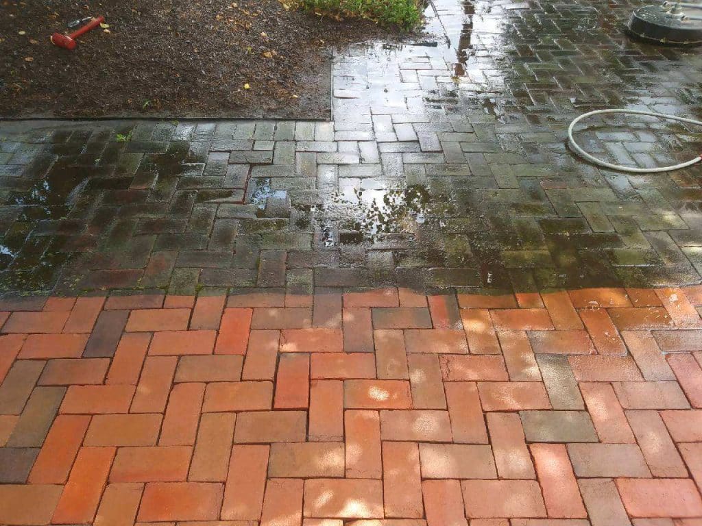 brick pathway being cleaned, half is clean, half is not